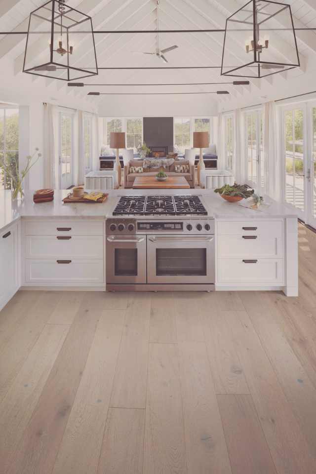 white oak engineered hardwood in open concept kitchen living room with surround windows and white vaulted ceilings